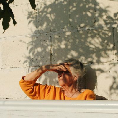 Dynamic shadow of a person moving gracefully against a gray wall